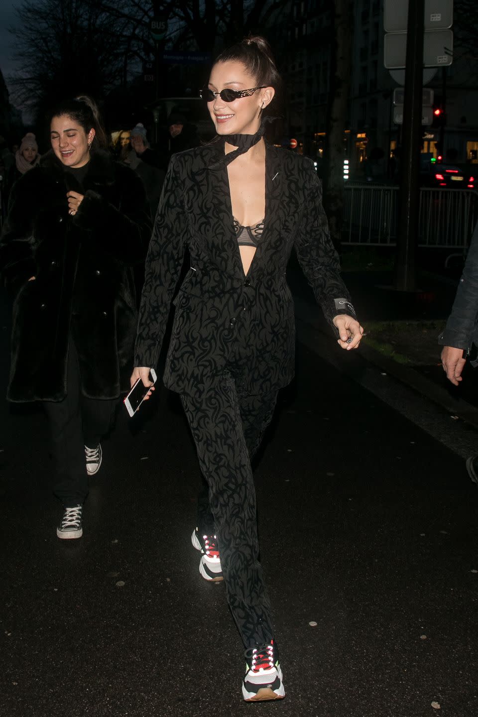 <p>In Paris heading to the Dior menswear show. Wearing a black suit without a shirt, with a neck tie, sunglasses, and sneakers.</p>