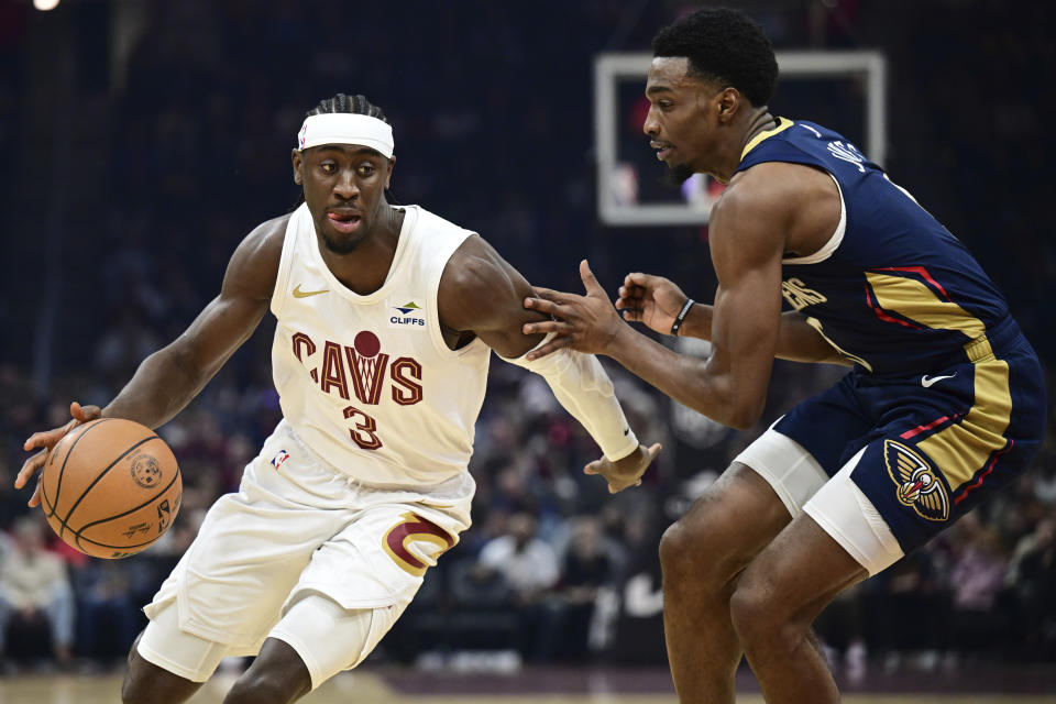 Cleveland Cavaliers guard Caris LeVert drives against New Orleans Pelicans forward Herbert Jones during the first half of an NBA basketball game Thursday, Dec. 21, 2023, in Cleveland. (AP Photo/David Dermer)