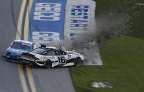 A J Allmendinger (16) and Austin Cindric (22) crash during the NASCAR Xfinity Series road course auto race at Daytona International Speedway, Saturday, Feb. 20, 2021, in Daytona Beach, Fla. Allmendinger was leading the race at the time. (AP Photo/Terry Renna)