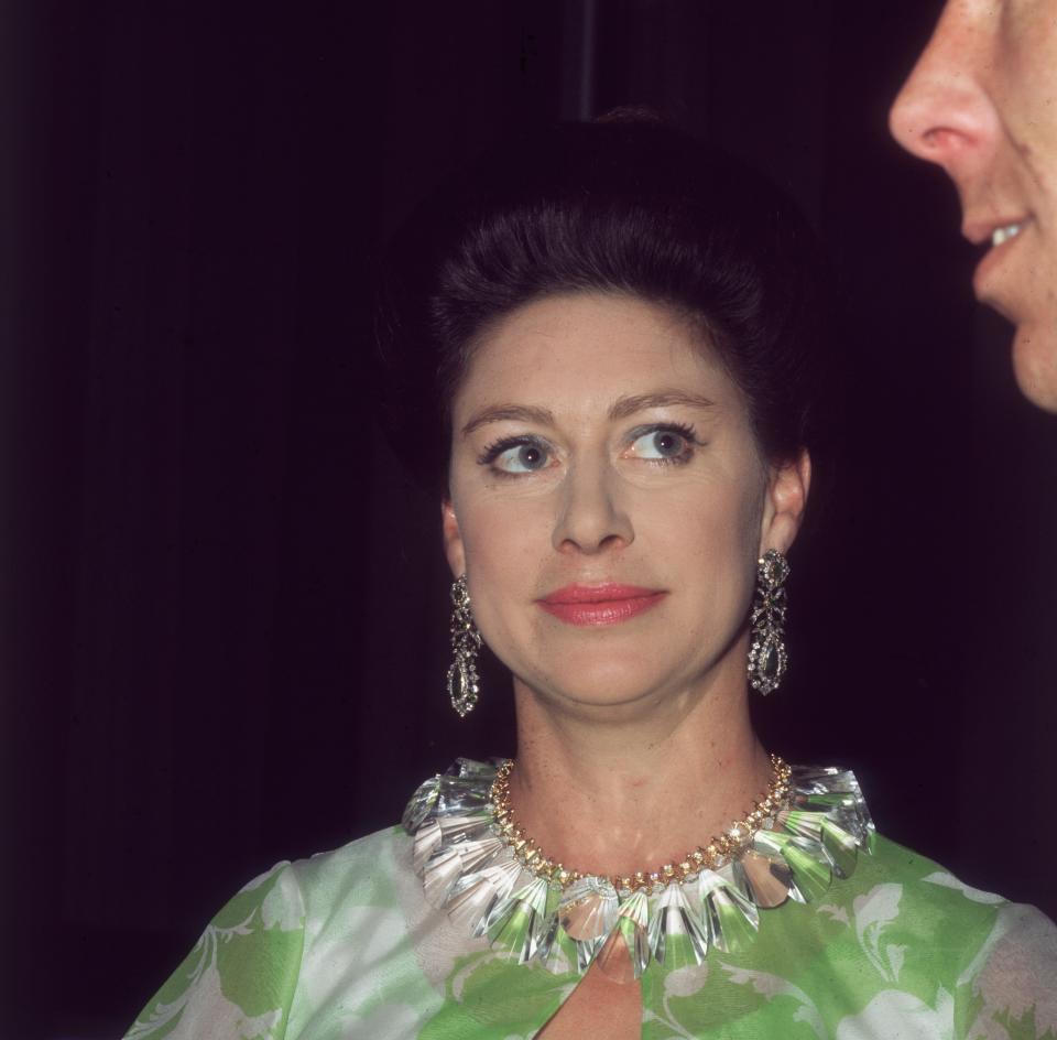 7th May 1970:  Princess Margaret (1930 - 2002) at the Royal Festival Hall after a Frank Sinatra concert in aid of the NSPCC, she is looking up at her husband Lord Snowdon.  (Photo by Mike Lawn/Fox Photos/Getty Images)