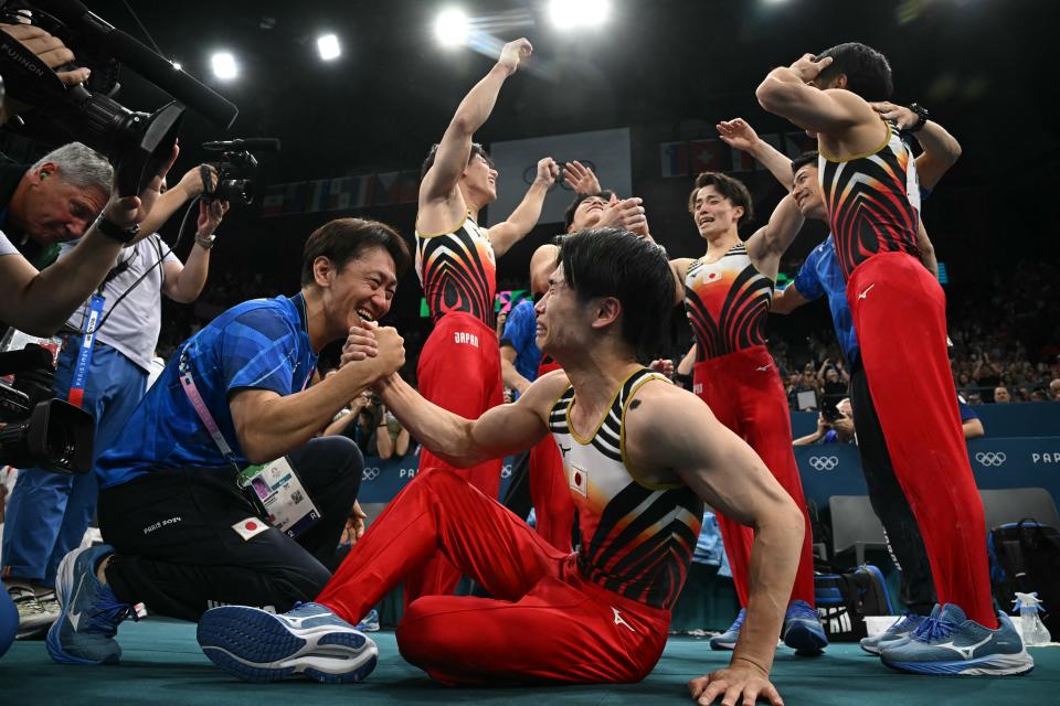 Team Japan celebrates after winning the gold medal during the artistic gymnastics men's team final at the Paris Olympics. (PAUL ELLIS/AFP via Getty Images)