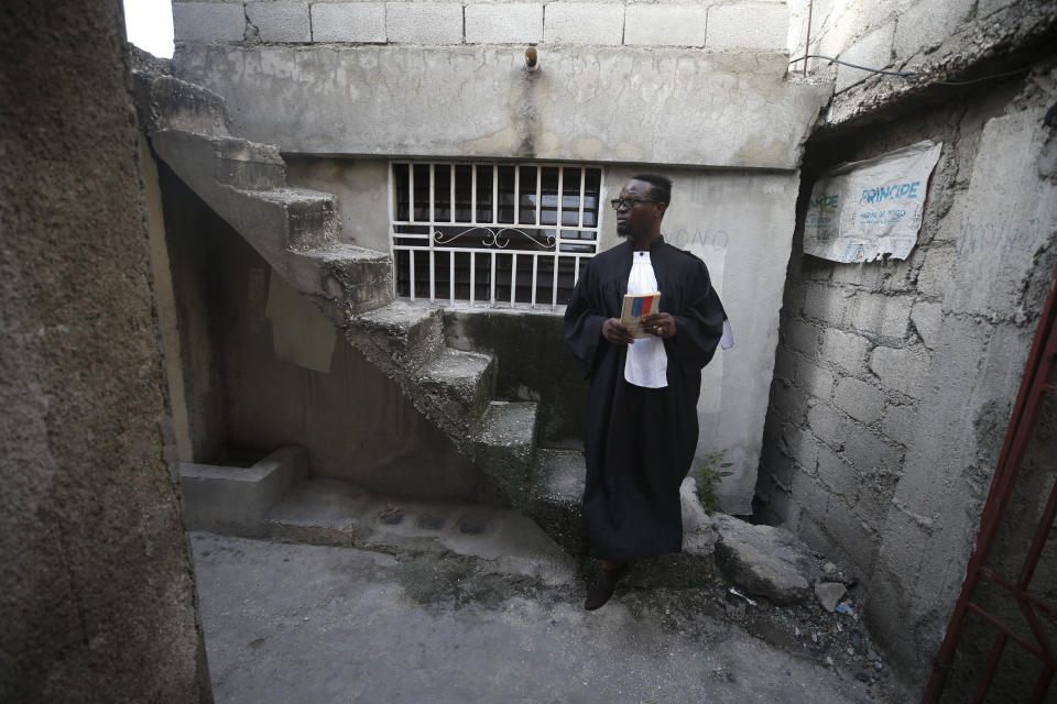 Entrepreneur and youth leader Pascéus Juvensky St. Fleur, who studied as a lawyer, descends a staircase in the legal robe he often wears at anti-government protests, following an interview with the AP in his Delmas neighborhood of Port-au-Prince, Haiti, Tuesday, Oct. 8, 2019. St. Fleur says the protests are not only about replacing a president, but changing a system. "It's not one person, it's not one regime, it's not a president, it's not the opposition, it's not the bourgeoisie, but it's us who should do it," he said. "We dream of, and we want, a better Haiti."(AP Photo/Rebecca Blackwell)