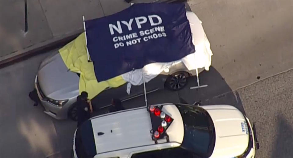 A car covered in sheets as a crime scene is erected in New York. Two babies died in the car after their dad left them inside for eight hours while he worked. Source: NBCNY