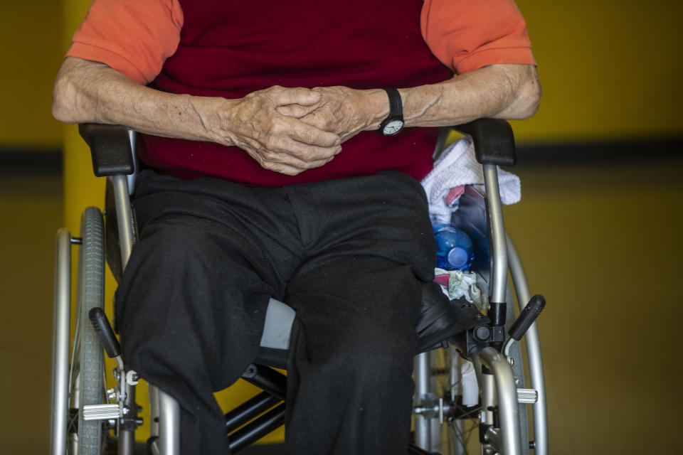 Francesco Bassanelli, 83, sits in a wheelchair during a visit by his family at the Martino Zanchi Foundation nursing home in Alzano Lombardo, Italy, Friday, May 29, 2020. (AP Photo/Luca Bruno)