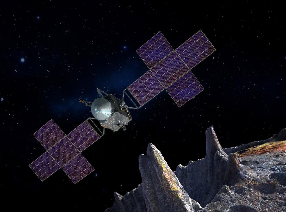 An artist's concept of a spacecraft floating in psace above the rocky surface of a planet.