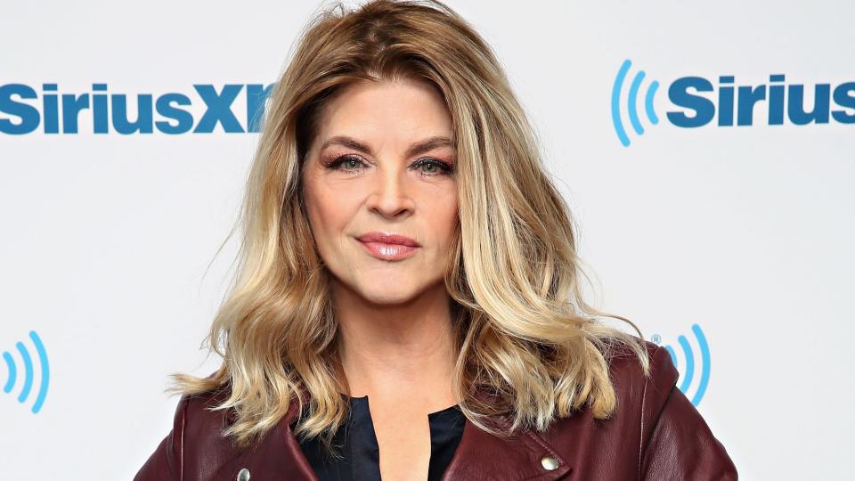 kirstie alley standing with her hands on her hips for a photo