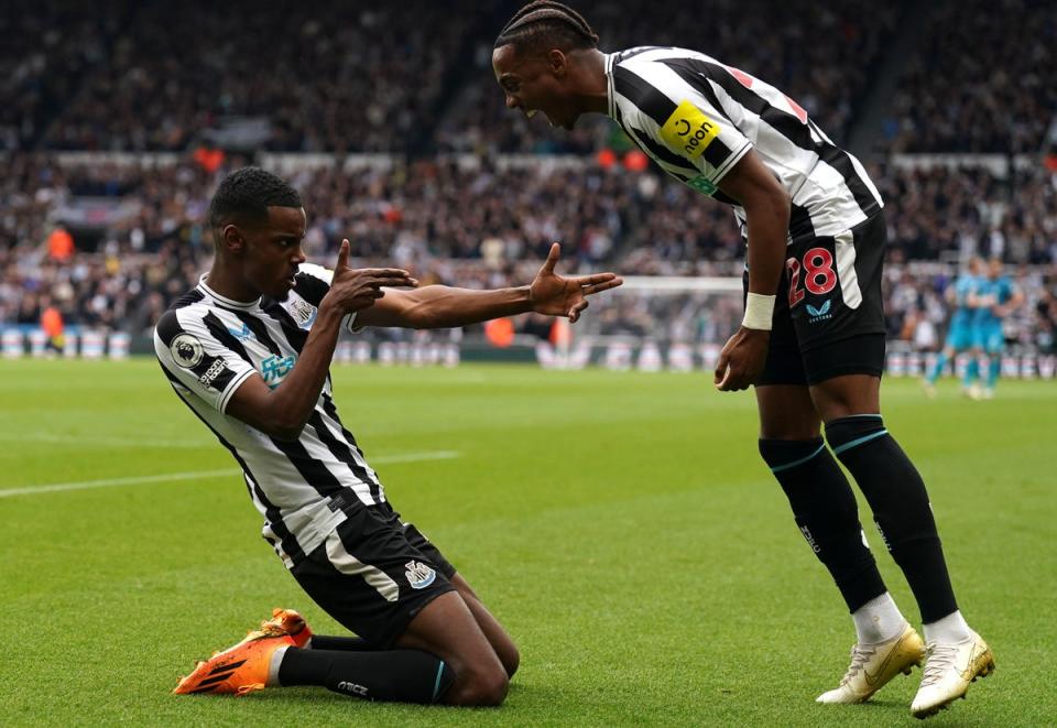 Alexander Isak celebrates with teammate Joe Willock after scoring Newcastle’s fourth goal of the game (PA)