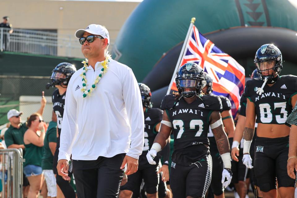 Head coach Timmy Chang of the Hawai'i Rainbow Warriors leads his team out of the locker room before the game against the Vanderbilt Commodores at the Clarance T.C. Ching Athletic Complex on August 27, 2022 in Honolulu, Hawaii.