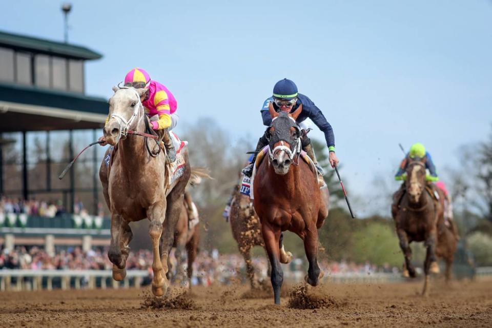 Tapit Trice, left, holds off Verifying to win the Toyota Blue Grass Stakes at Keeneland on Saturday.