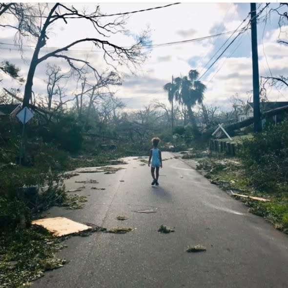 Child walks down Michael-damaged street in Panama City, Florida