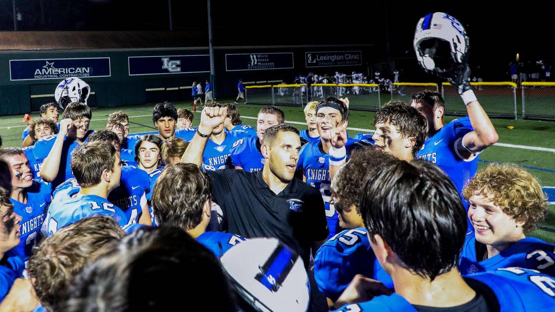 Lexington Catholic head coach Bert Bathiany, center, celebrates with his team after a victory this season.