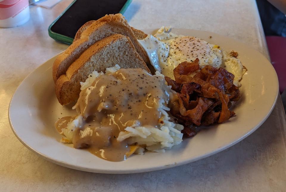 Comfort food abounds at the Kalona Sales Barn restaurant, prepared and served by Mennonite women for the visitors, bidders and sellers. This hearty farm breakfast includes gravy-smothered hash browns and a pile of bacon.