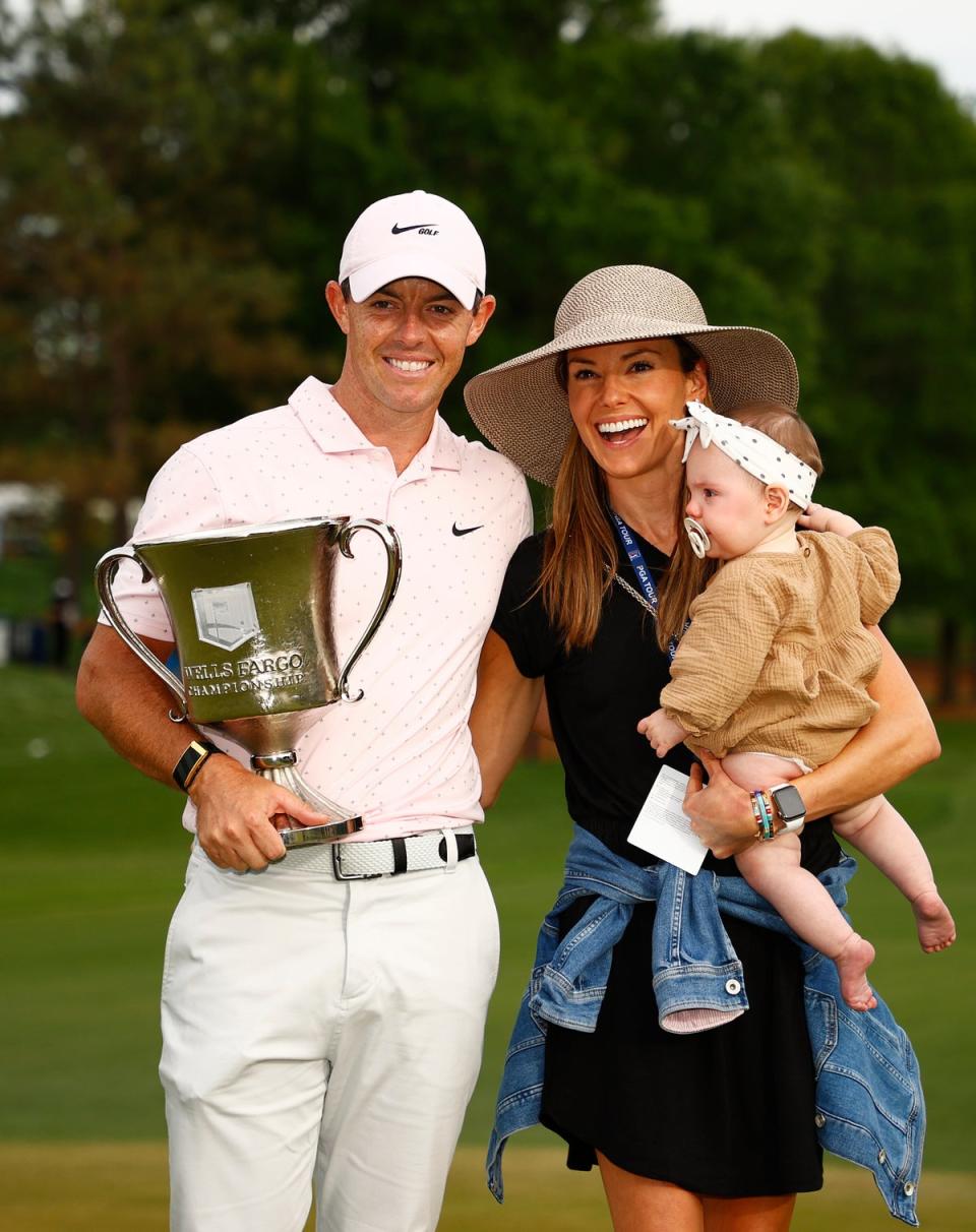 Rory McIlroy of Northern Ireland celebrates with his wife Erica and daughter Poppy after winning the 2021 Wells Fargo Championship ((Photo by Jared C. Tilton/Getty Images))