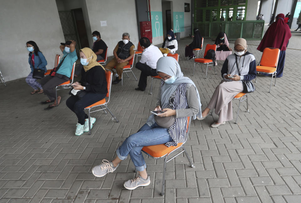 People wait for a coronavirus rapid test at the Patriot Candrabhaga Stadium in Bekasi, Indonesia, Monday, Jan. 25, 2021. Indonesia has reported more cases of the virus than any other countries in Southeast Asia. (AP Photo/Achmad Ibrahim)