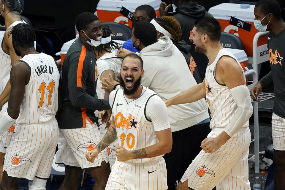 Orlando Magic's Evan Fournier (10) celebrates the game-winning basket by Cole Anthony at the end of an NBA basketball game against the Minnesota Timberwolves, Wednesday, Jan. 20, 2021, in Minneapolis. The Magic won 97-96. (AP Photo/Jim Mone)