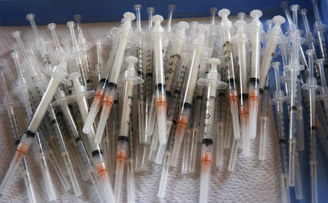 Syringes loaded with Moderna COVID-19 vaccine wait for customers at a Whitebird clinic at the WOW Hall in Eugene. 