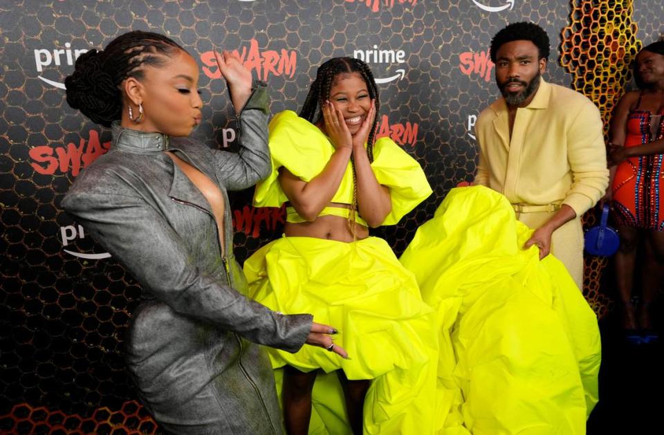 Dominique Fishback, center, a cast member in “Swarm,” is joined by fellow cast member Chloe Bailey, left, and co-creator/director/executive producer Donald Glover at the premiere of the Amazon Prime Video series, Tuesday, March 14, 2023, at Lighthouse ArtSpace in Los Angeles. (AP Photo/Chris Pizzello)