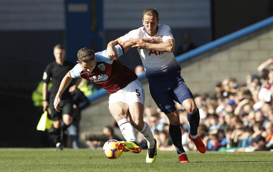 Tottenham Hotspur's Harry Kane, right, and Burnley's James Tarkowski during their English Premier League soccer match at Turf Moor in Burnley, England, Saturday Feb. 23, 2019. (Martin Rickett/PA via AP)