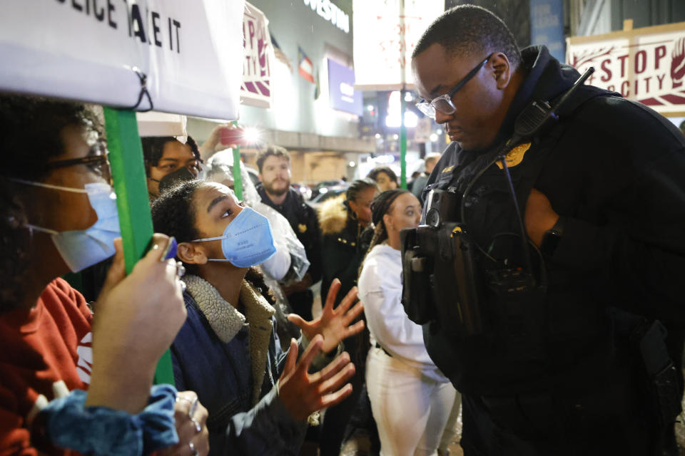 FILE - Demonstrators confront an Atlanta police officer during a protest over plans to build a new police training center, March 9, 2023, in Atlanta. Sixty-one people have been indicted in Georgia on racketeering charges following a long-running state investigation into protests against a proposed police and training facility in the Atlanta area that critics call “Cop City.” The Tuesday, Aug. 29, 2023, indictment under the state’s racketeering law was released by Fulton County officials on Tuesday, Sept. 5. (AP Photo/Alex Slitz, File)