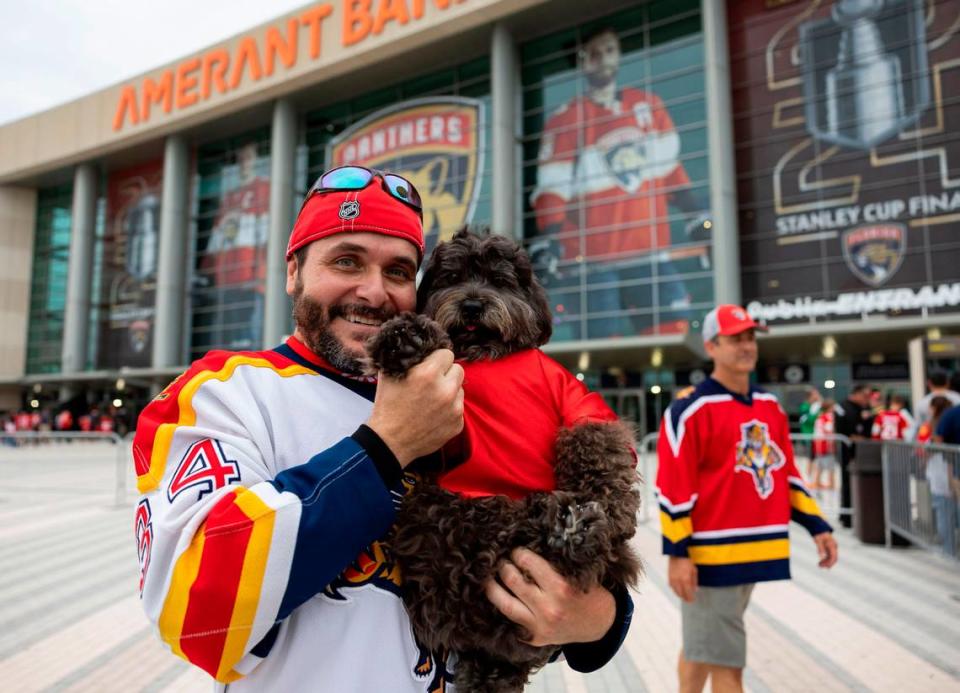 Florida Panthers fan Jorge Ulloa, 48, and his dog, Rocky, arrive to a watch party at the Amerant Bank Arena to see their team play against the Edmonton Oilers in Game 4 of the NHL Stanley Cup Final