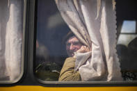 A man waits in a bus to be processed as he arrives with others at a reception center for displaced people in Zaporizhzhia, Ukraine, Monday, May 2, 2022. Thousands of Ukrainian continue to leave Russian occupied areas. (AP Photo/Francisco Seco)