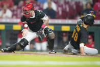 Pittsburgh Pirates' Hoy Park (68) scores a run ahead of the tag from Cincinnati Reds' catcher Tucker Barnhart (16) during the sixth inning of a baseball game in Cincinnati, Tuesday, Sept 21, 2021. (AP Photo/Bryan Woolston)