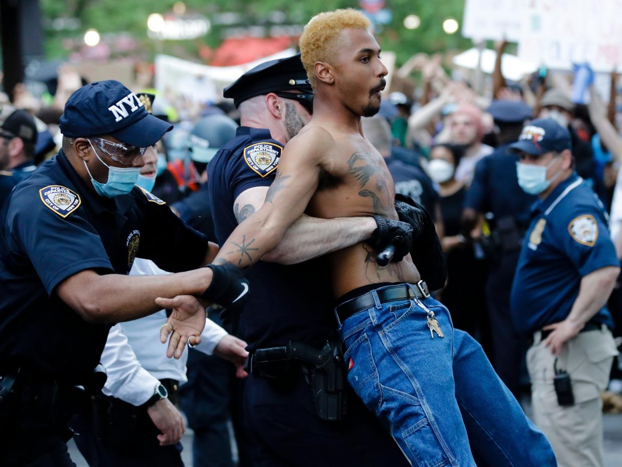 A protester is arrested during a rally at the Barclays Center over the death of George Floyd, a black man who was in police custody in Minneapolis Friday, May 29, 2020, in the Brooklyn borough of New York. (AP Photo:Frank Franklin II)