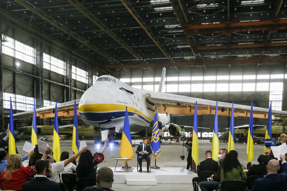 Ukrainian President Volodymyr Zelenskyy speaks to the media during a news conference with the world's largest airplane, Ukrainian Antonov An-225 Mriya in the background at the Antonov aircraft factory in Kyiv, Ukraine, Thursday, May 20, 2021. (AP Photo/Efrem Lukatsky)