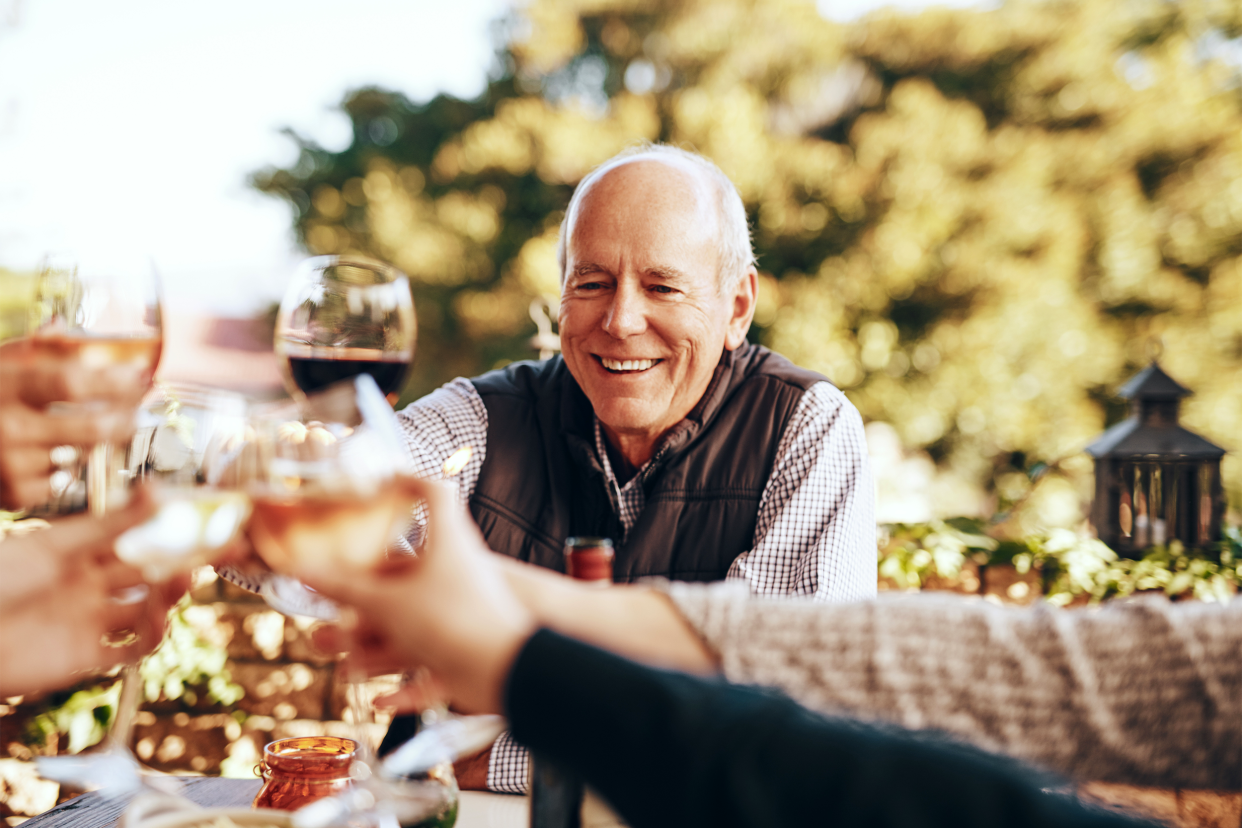 Man drinking wine with family