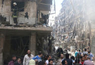 People inspect the damage at a site hit by airstrikes, in the rebel-held area of Aleppo's Bustan al-Qasr. REUTERS/Abdalrhman Ismail