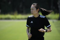 Japanese referee Yoshimi Yamashita warms up during a training session Monday, June 27, 2022, at JFA YUME Field in Chiba, near Tokyo. Yamashita is one three three women picked in a pool of 36 head referees for the men's World Cup in Qatar, which opens in just under five months on Nov. 21. It's the first time a female will be in charge on soccer largest stage. (AP Photo/Eugene Hoshiko)