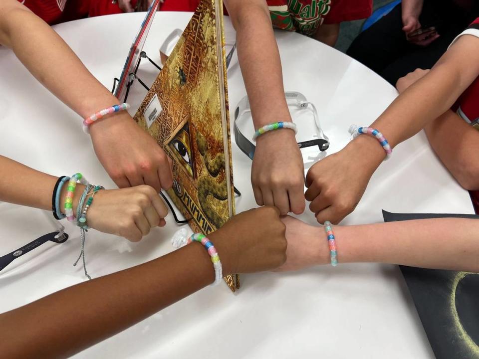 Fifth-grade students at Alice Carlson Applied Learning Center in Fort Worth who helped organize lesson plans and activities for the school in preparation for the solar eclipse show off their “UV bracelets” on Monday, April 8, 2024. The colors of the beads are supposed to get brighter in the sunlight and serve as a visual indicator that the eclipse is happening. The beads should turn less bright when the moon blocks the sun. Lina Ruiz/lruiz@star-telegram.com