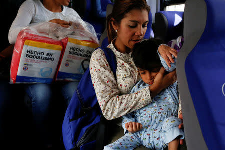 Norymar Torres carries her son Leonardo Colmenares, 6, neurological patient being treated with anticonvulsants, while they travel on public transport in Caracas, Venezuela January 18, 2017. REUTERS/Carlos Garcia Rawlins