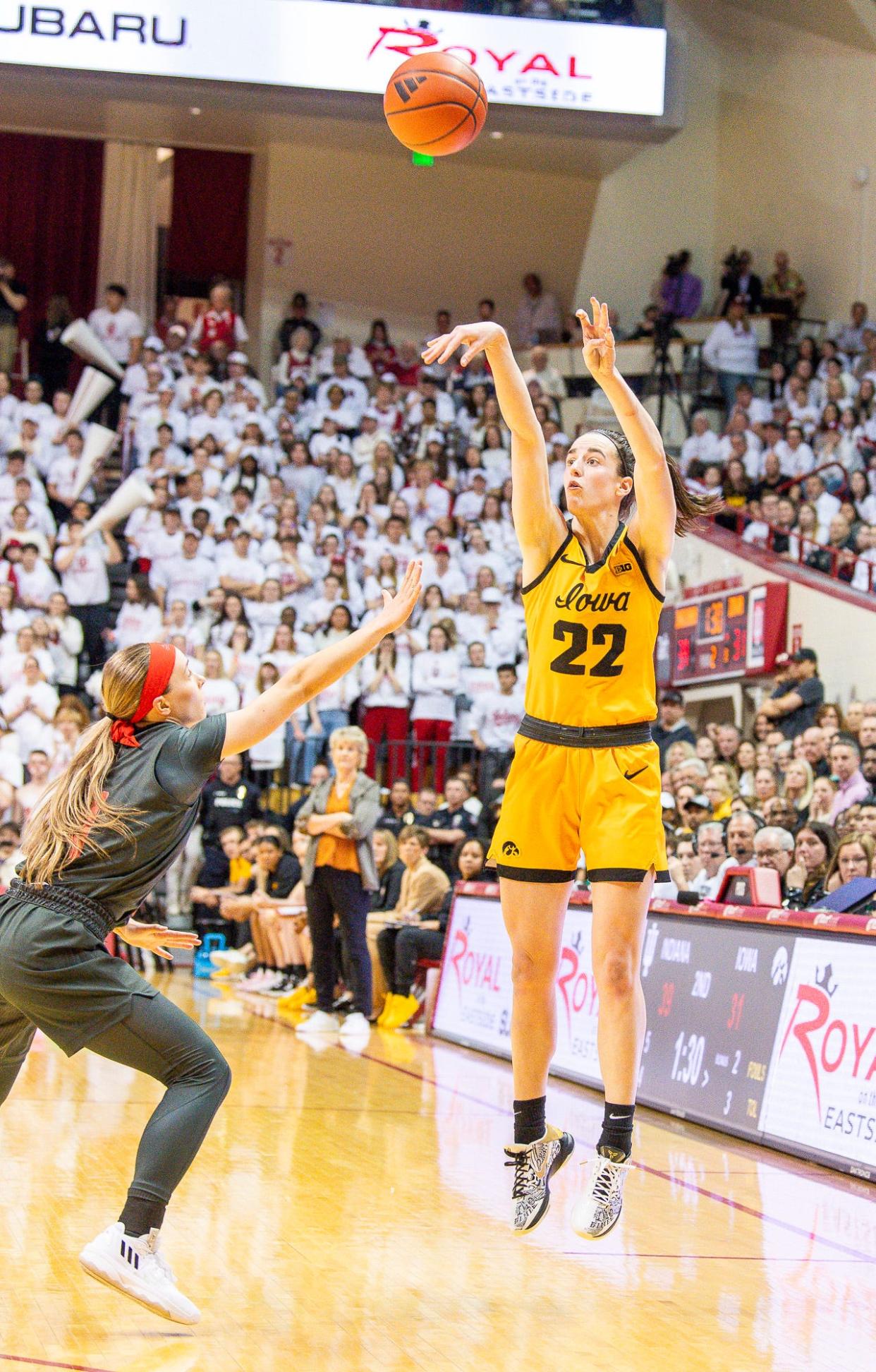 Iowa's Caitlin Clark (22) shoots over Indiana's Sara Scalia (14) during the first half of the Indiana versus Iowa women's basketball game at Simon Skjodt Assembly Hall on Thursday, Feb. 22, 2024.