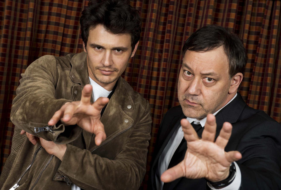 FILE - In this Sunday, Feb. 17, 2013 file photo, actor James Franco, left, and director Sam Raimi pose for portraits at the "Oz The Great and Powerful" press junket at the Langham Huntington Hotel, in Los Angeles. Returning to the mystical land of “The Wizard of Oz” apparently takes more than 70 years and hundreds of millions of dollars. Disney will release its anticipated prequel to the 1939 movie on Friday, Feb. 7, 2013. Directed by Raimi, “Oz the Great and Powerful” explores the origins of the wizard (James Franco) and the witches (Mila Kunis, Michelle Williams and Rachel Weisz) in a three-dimensional Oz. (Photo by Jordan Strauss/Invision/AP, File)