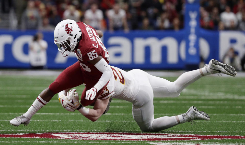 Washington State wide receiver Calvin Jackson Jr. (85) is hit by Iowa State linebacker Mike Rose (23) after making a catch during the the first half of the Alamo Bowl NCAA college football game Friday, Dec. 28, 2018, in San Antonio. (AP Photo/Eric Gay)
