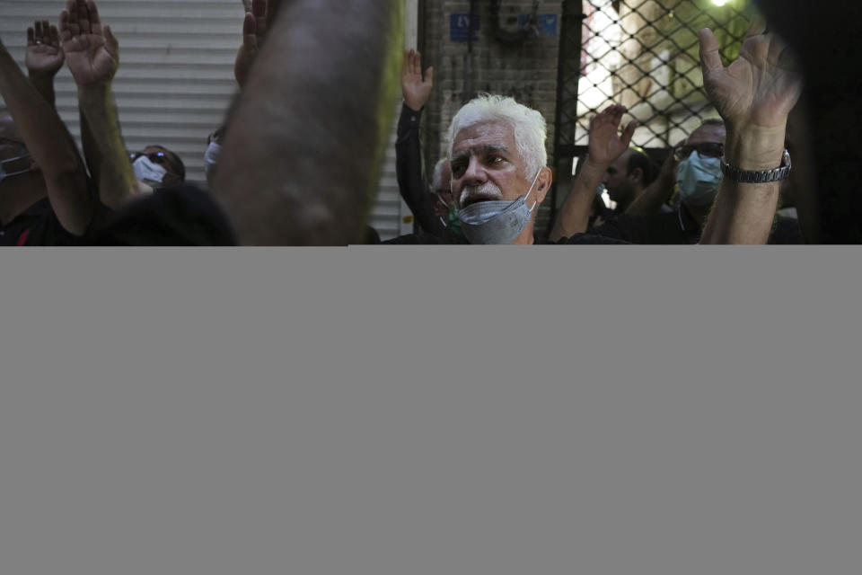 Mourners strike their chests in an annual procession commemorating Ashoura which marks the death anniversary of Imam Hussein, the grandson of Prophet Muhammad, who was killed with 72 of his companions in the 7th century in the Battle of Karbala in present-day Iraq, in Tehran, Iran, Monday, Aug. 8, 2022. (AP Photo/Vahid Salemi)