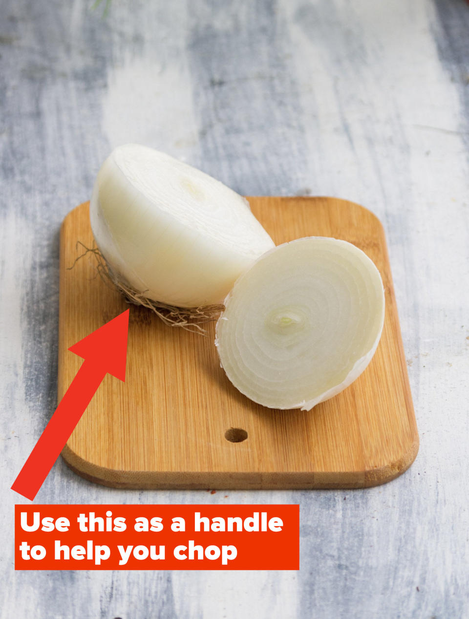 A halved white onion on a wooden table.