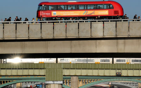 Workers are seen crossing London Bridge during the morning rush hour in London, Britain, September 25, 2018. REUTERS/Toby Melville