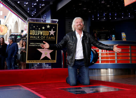 Richard Branson poses by his star after it was unveiled on the Hollywood Walk of Fame in Los Angeles, California, U.S., October 16, 2018. REUTERS/Mario Anzuoni