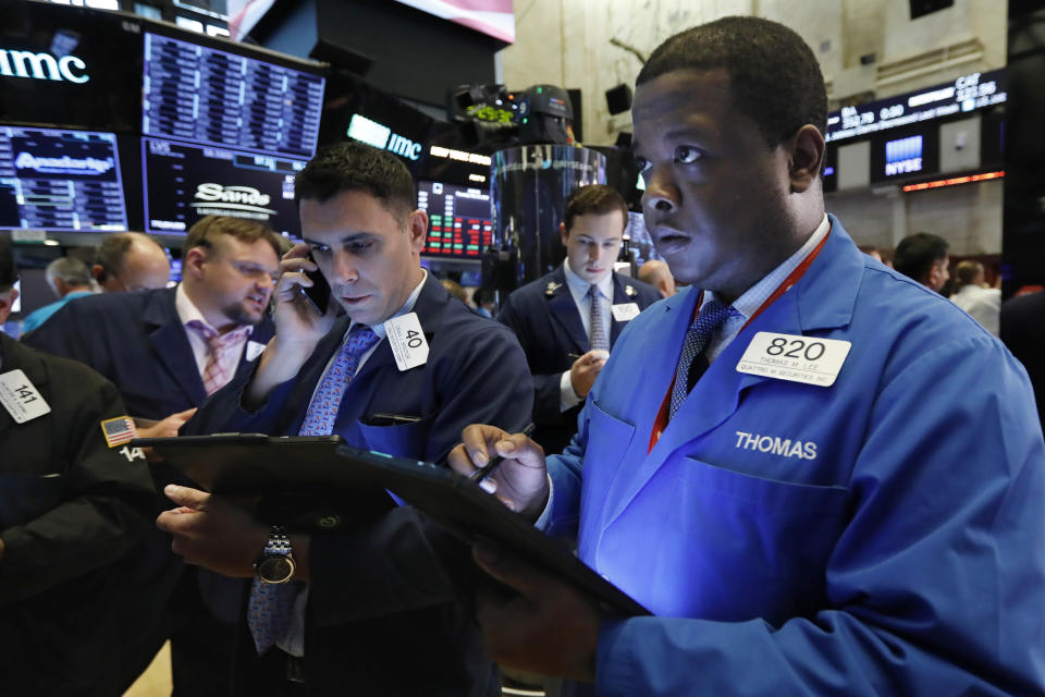 Thomas Lee, right, works with fellow traders on the floor of the New York Stock Exchange, Thursday, May 23, 2019. Stocks are falling at the open on Wall Street as investors worry about an apparent stalemate in trade talks between the U.S. and China. (AP Photo/Richard Drew)