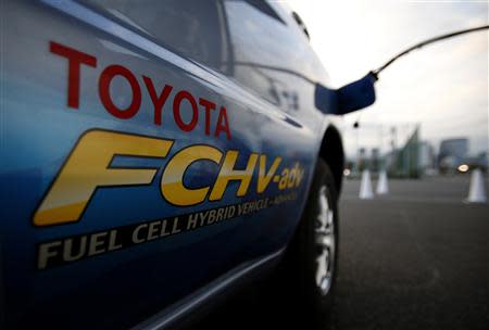 A hydrogen nozzle is plugged into a Toyota Fuel Cell Hybrid Vehicle during the Toyota Advanced Technologies media briefing in Tokyo in this October 10, 2013 file photo. REUTERS/Yuya Shino/Files