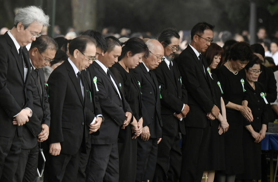 People offer silent prayer during a ceremony to mark the 74th anniversary of the atomic bombing at the Hiroshima Peace Memorial Park in Hiroshima, western Japan Tuesday, Aug. 6, 2019. (Kyodo News via AP)