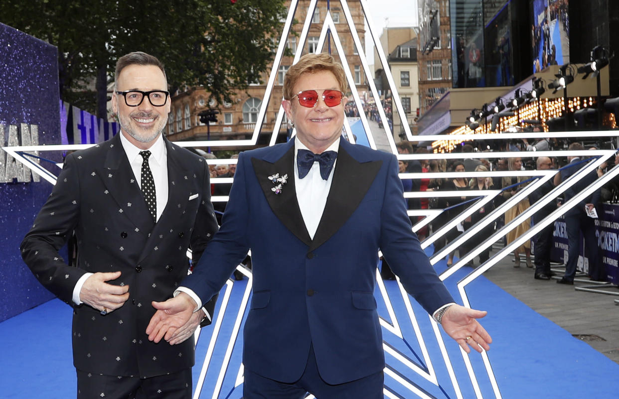 Musician Elton John and producer David Furnish, left, arrive for the UK Film Premiere of Rocketman at the Odeon Luxe in London, Monday, May 20, 2019.(AP Photo/Frank Augstein)