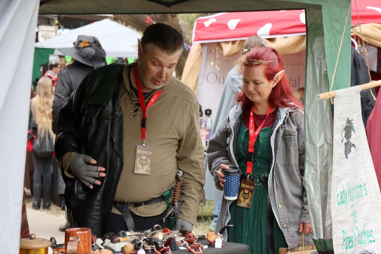 Michael Thomas and Betty Walker check out items for sale at the 2023 Cottonwood Renaissance Faire held at Thompson Park.