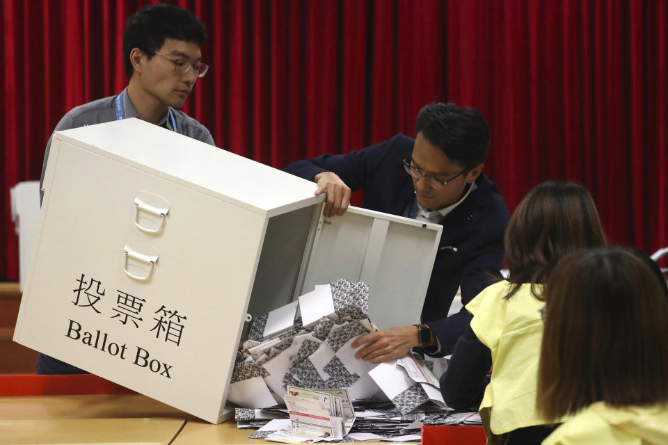 Election workers empty a ballot box to count votes for a district council election at a polling station in Hong Kong, Sunday, Nov. 24, 2019. One year ago, a sea of humanity - a million people by some estimates - marched through central Hong Kong on a steamy afternoon. It was the start of what would grow into the longest-lasting and most violent anti-government movement the city has seen since its return to China in 1997. (AP Photo/Ng Han Guan, File)