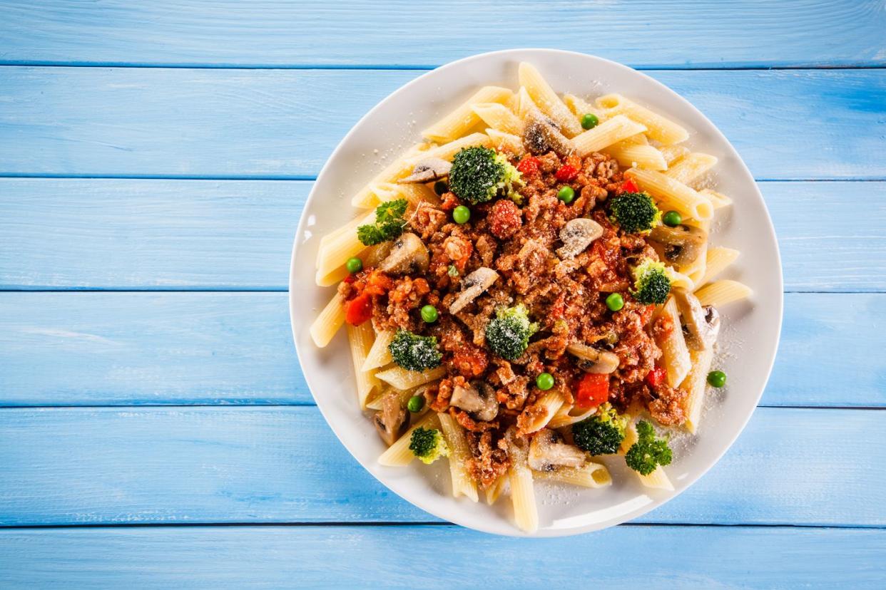 penne bolognese with broccoli and peas