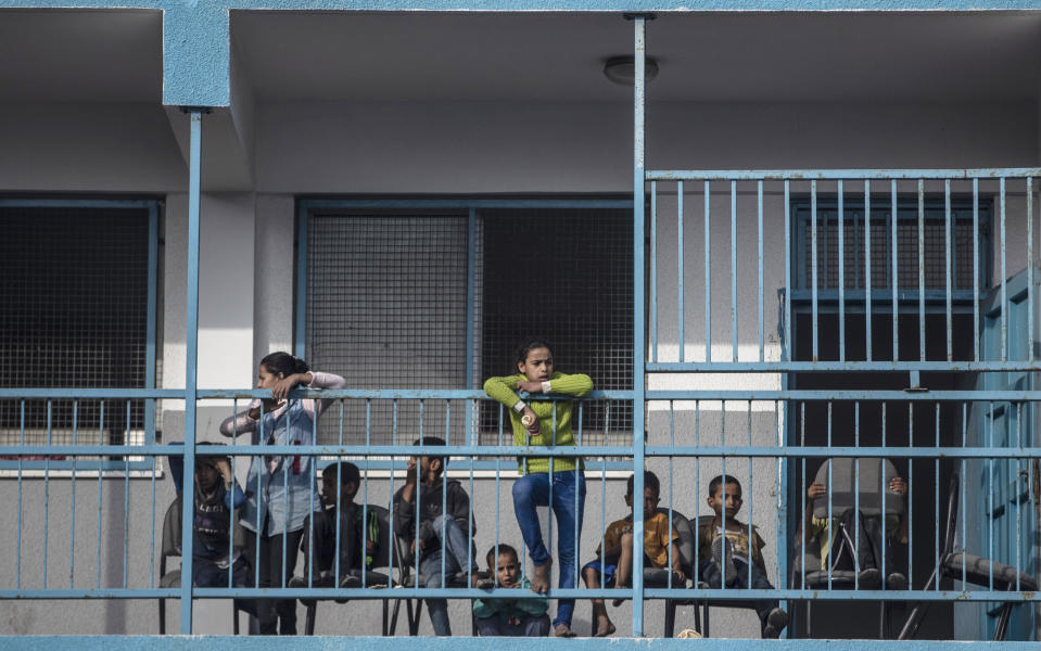 Palestinians take shelter provided by the U.N. at a school after fleeing their homes from the overnight Israeli heavy missile strikes on their neighborhoods in the outskirts of Gaza City, Friday, May 14, 2021. (AP Photo/Khalil Hamra)
