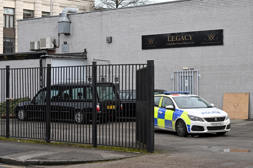 A police car is parked near a hearse outside a branch of Legacy Independent Funeral Directors in Hull, northeast England, on March 13, 2024. The bodies of 35 people and the suspected ashes of a number of others have been recovered by police investigating the funeral parlour after concerns were raised about 