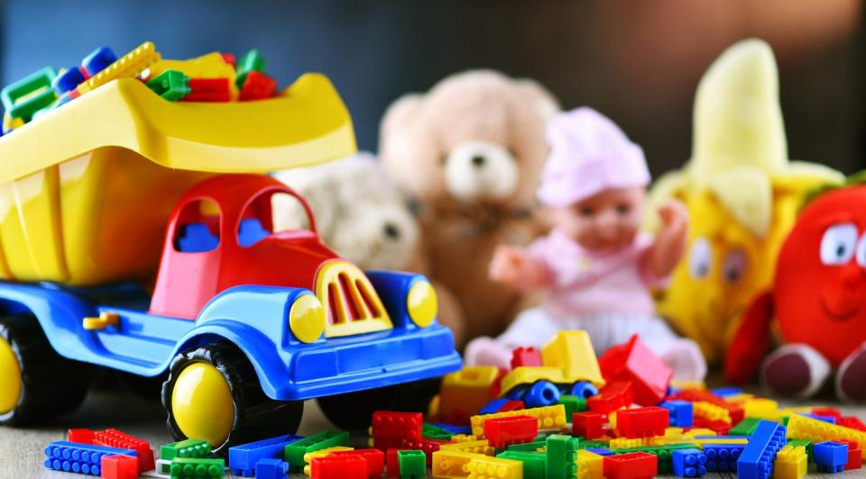 Colorful plastic and plush toys in a children's room.